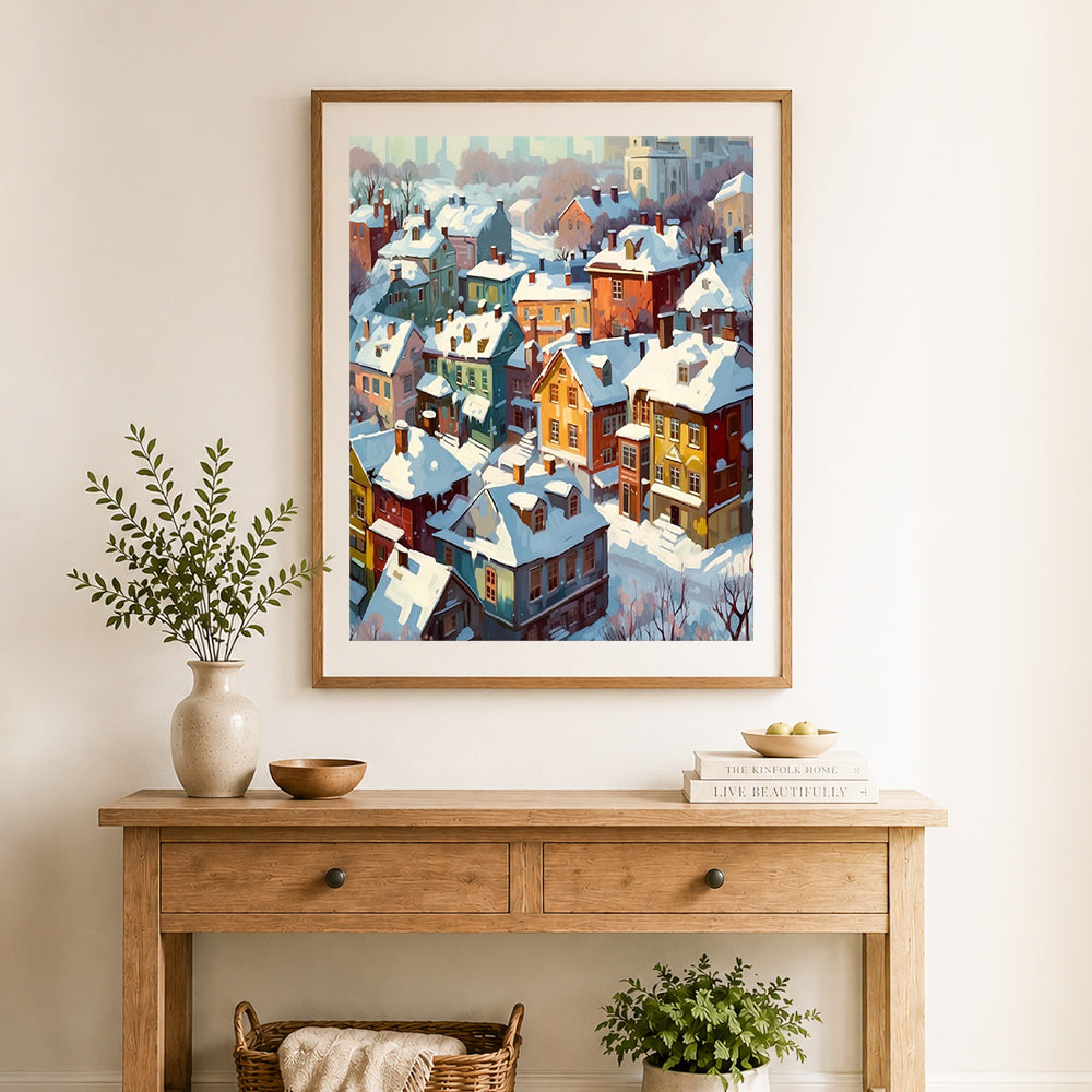 Finished cozy snow‑covered colorful town cross stitch artwork displayed as home decor