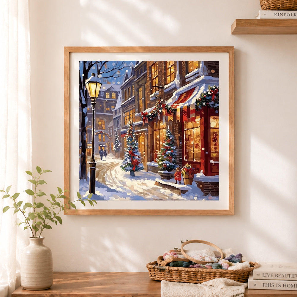 Finished cozy snowy christmas city cross stitch artwork displayed as home decor