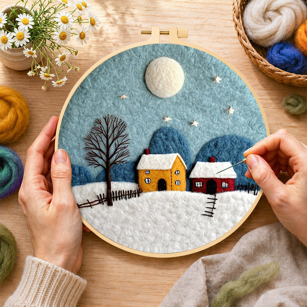 Creating the cozy village on a snowy night wool painting by hand with a felting needle