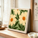 Creamy white daisy flowers punch needle artwork displayed on a table