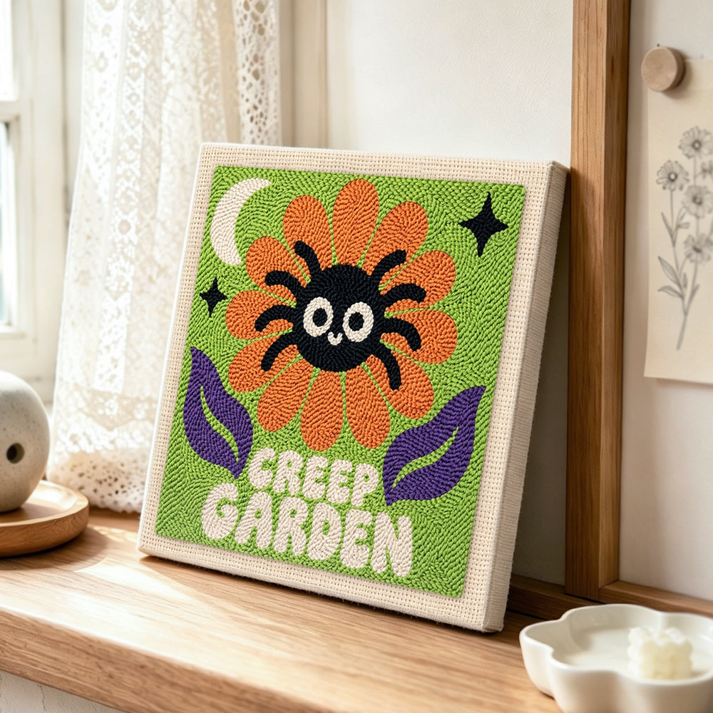 Creep garden spider flower punch needle artwork displayed on a table