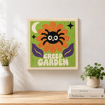 Finished creep garden spider flower artwork displayed on a wall