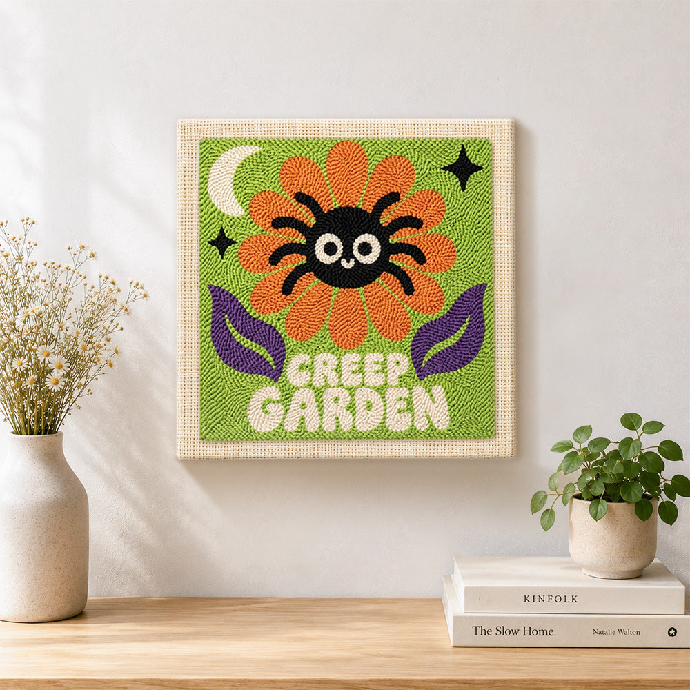 Finished creep garden spider flower artwork displayed on a wall