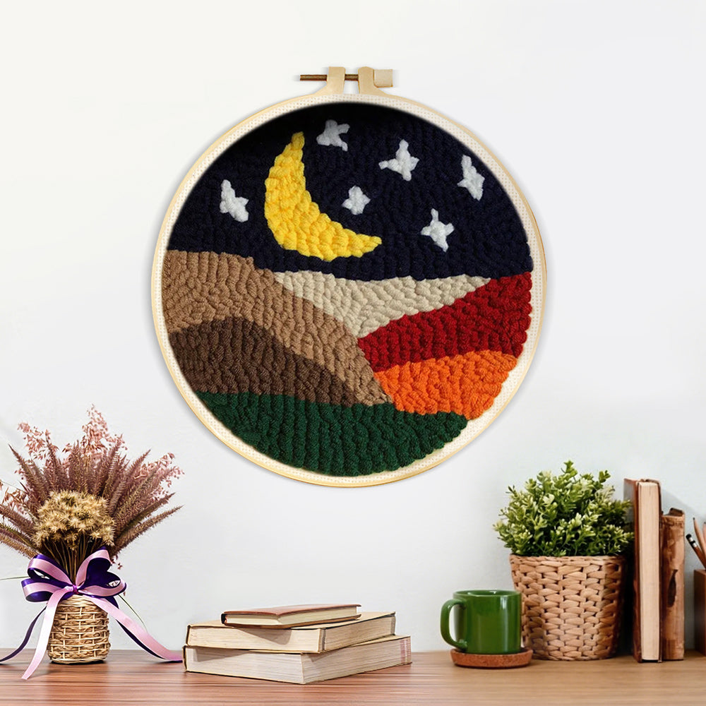 Finished crescent moon and white stars above the colorful mountains artwork displayed on a wall