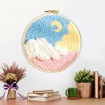 Finished crescent moon over colorful clouds artwork displayed on a wall