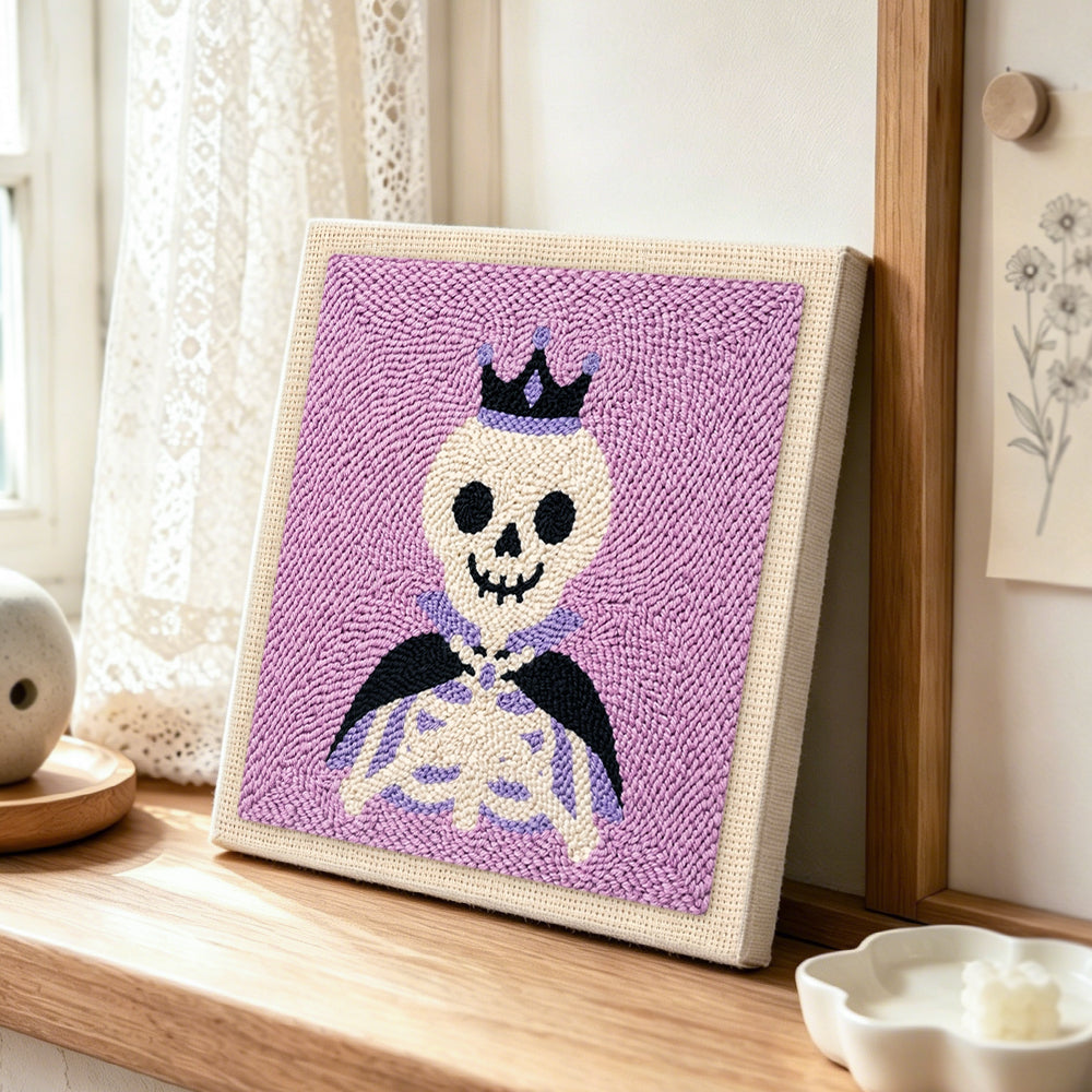 Crown skeleton punch needle artwork displayed on a table