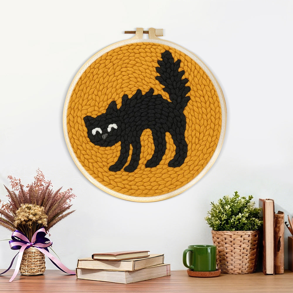 Finished curled black cat artwork displayed on a wall