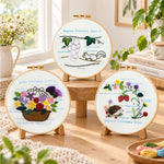 Cute animal themed stitch work embroidery kit finished hoop displayed on a wooden stand as cozy tabletop decor
