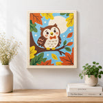 Finished cute autumn owl on branch artwork displayed on a wall