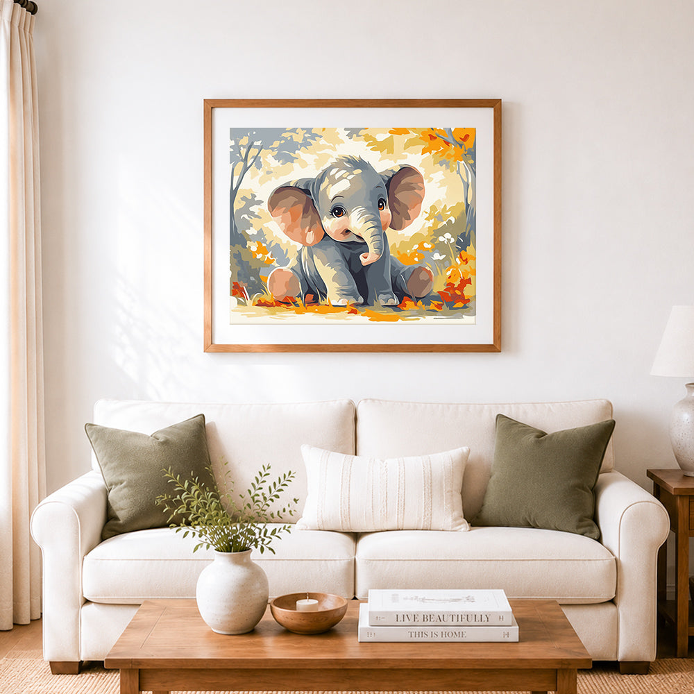 Finished cute baby elephant sitting in autumn leaves cross stitch artwork displayed as home decor
