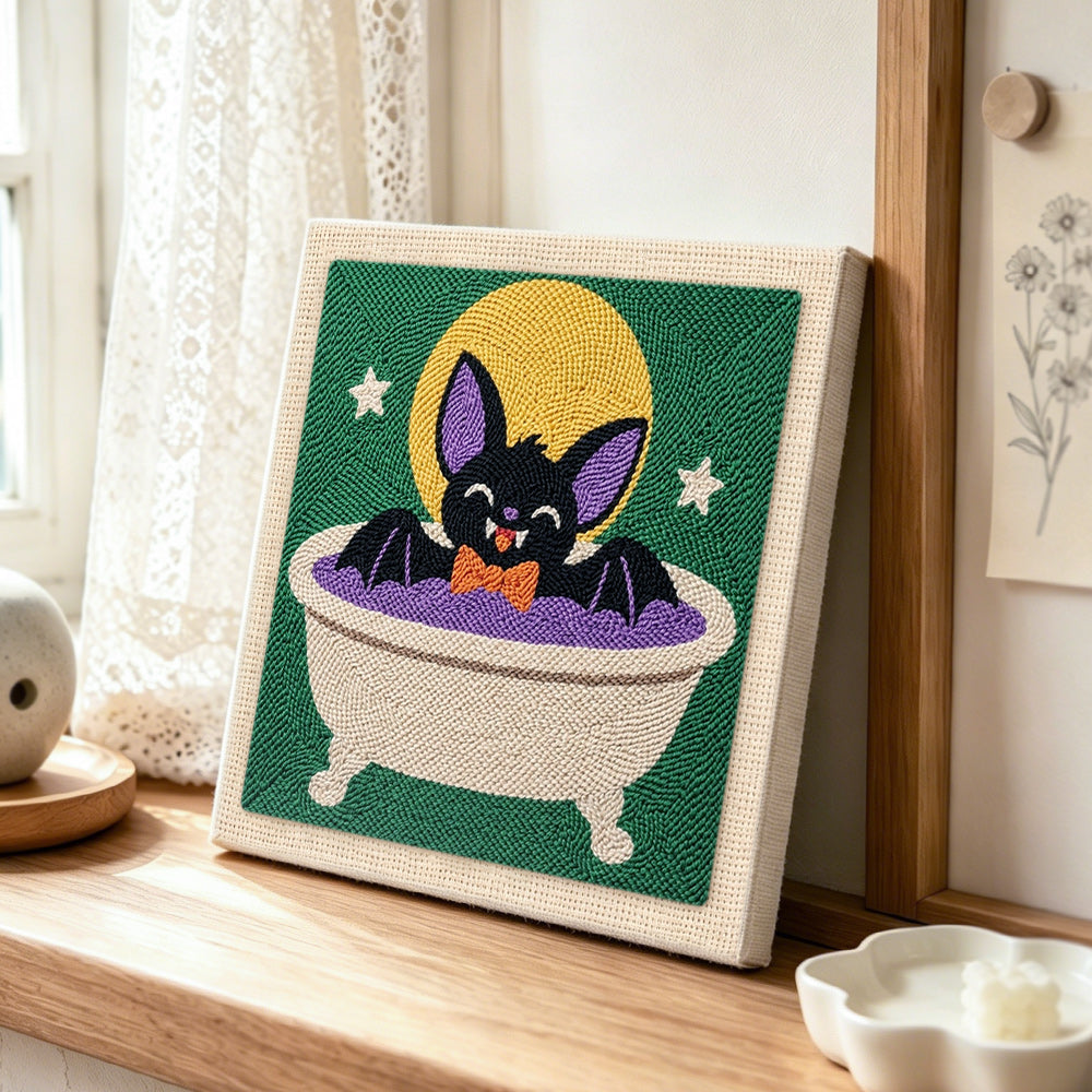 Cute bat taking bath punch needle artwork displayed on a table