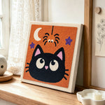 Cute black cat punch needle artwork displayed on a table