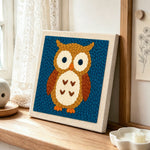 Cute brown owl punch needle artwork displayed on a table