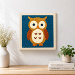 Finished cute brown owl artwork displayed on a wall