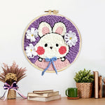 Finished cute bunny with blue bow artwork displayed on a wall