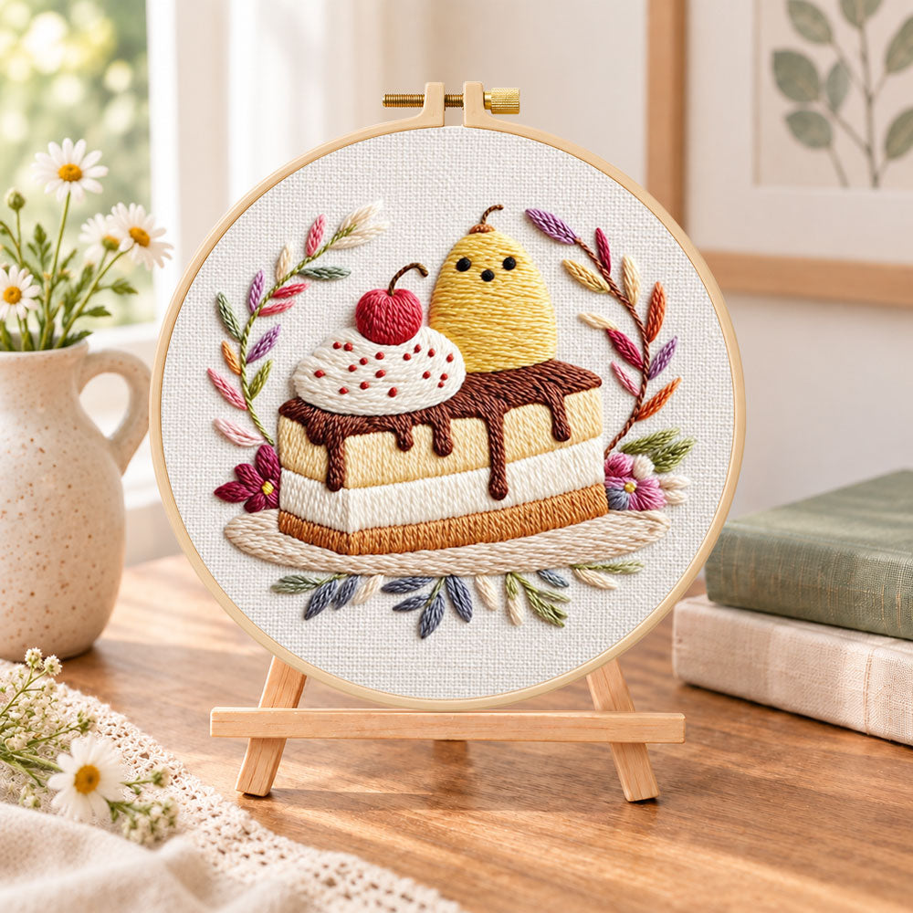 Cute cake art embroidery kit finished hoop displayed on a wooden stand as cozy tabletop decor