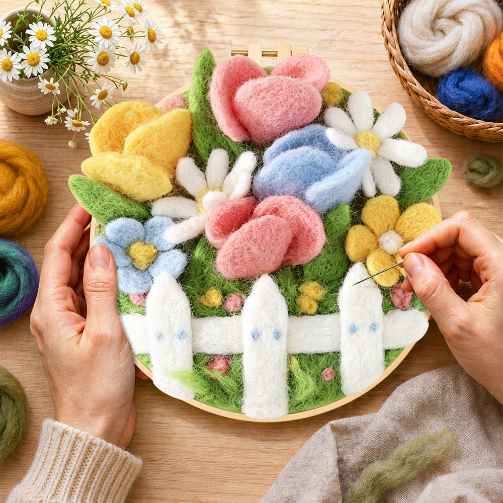 Creating the cute flower bed with white picket fence wool painting by hand with a felting needle