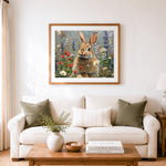 Finished cute fluffy bunny in wildflower meadow cross stitch artwork displayed as home decor