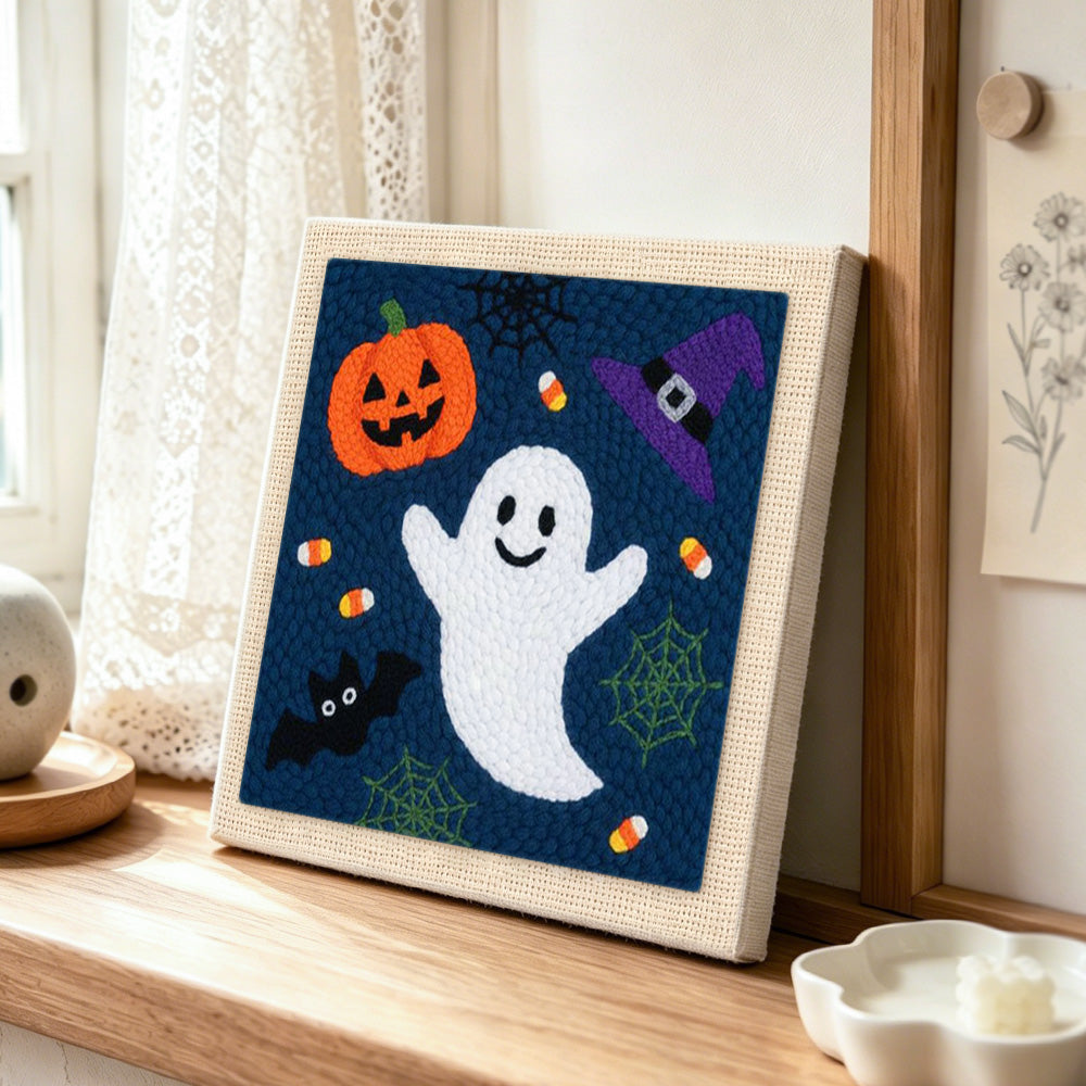 Cute ghost and pumpkin punch needle artwork displayed on a table