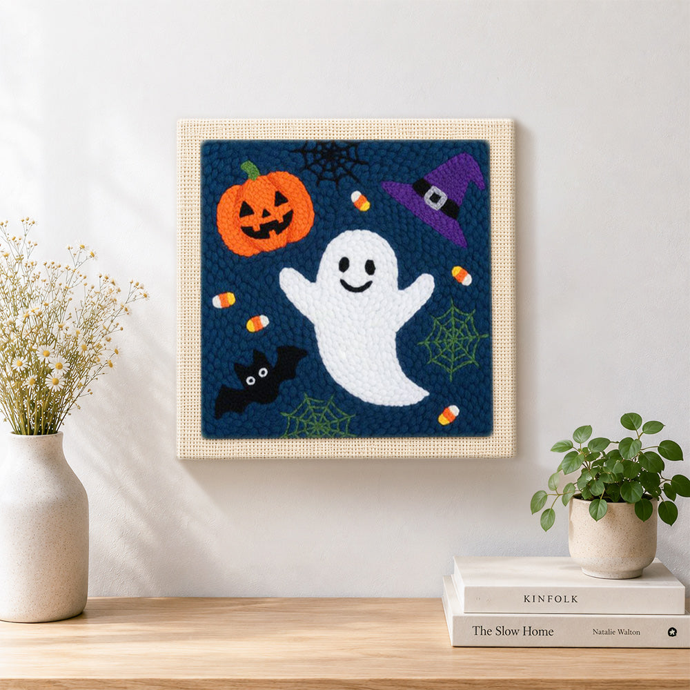 Finished cute ghost and pumpkin artwork displayed on a wall