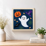 Finished cute ghost and pumpkin artwork displayed on a wall