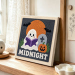 Cute ghost reading at midnight punch needle artwork displayed on a table