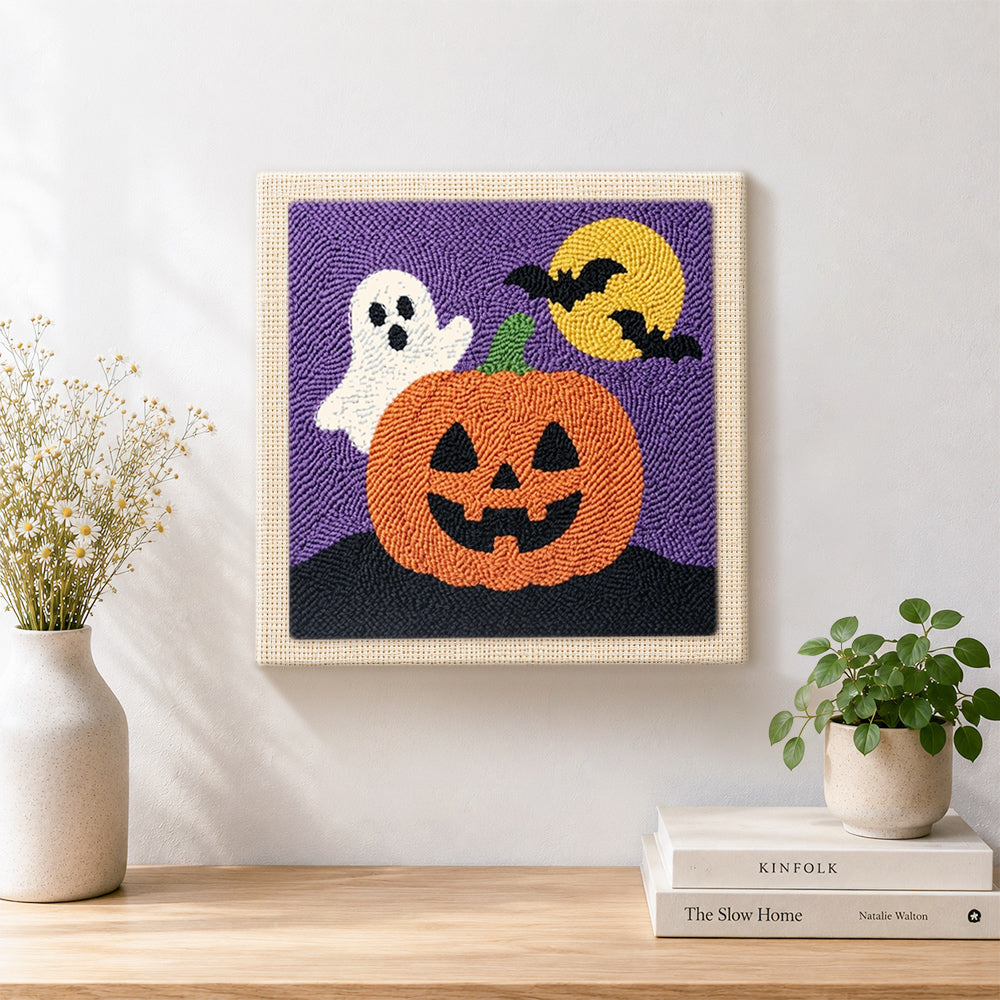 Finished cute ghost with jack‑o‑lantern artwork displayed on a wall