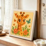 Cute giraffe with butterflies punch needle artwork displayed on a table