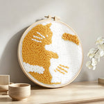 Cute golden cat punch needle artwork displayed on a table