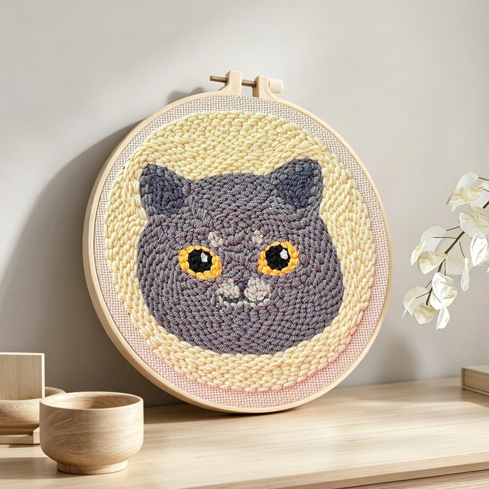 Cute gray cat punch needle artwork displayed on a table