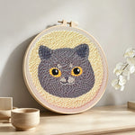 Cute gray cat punch needle artwork displayed on a table