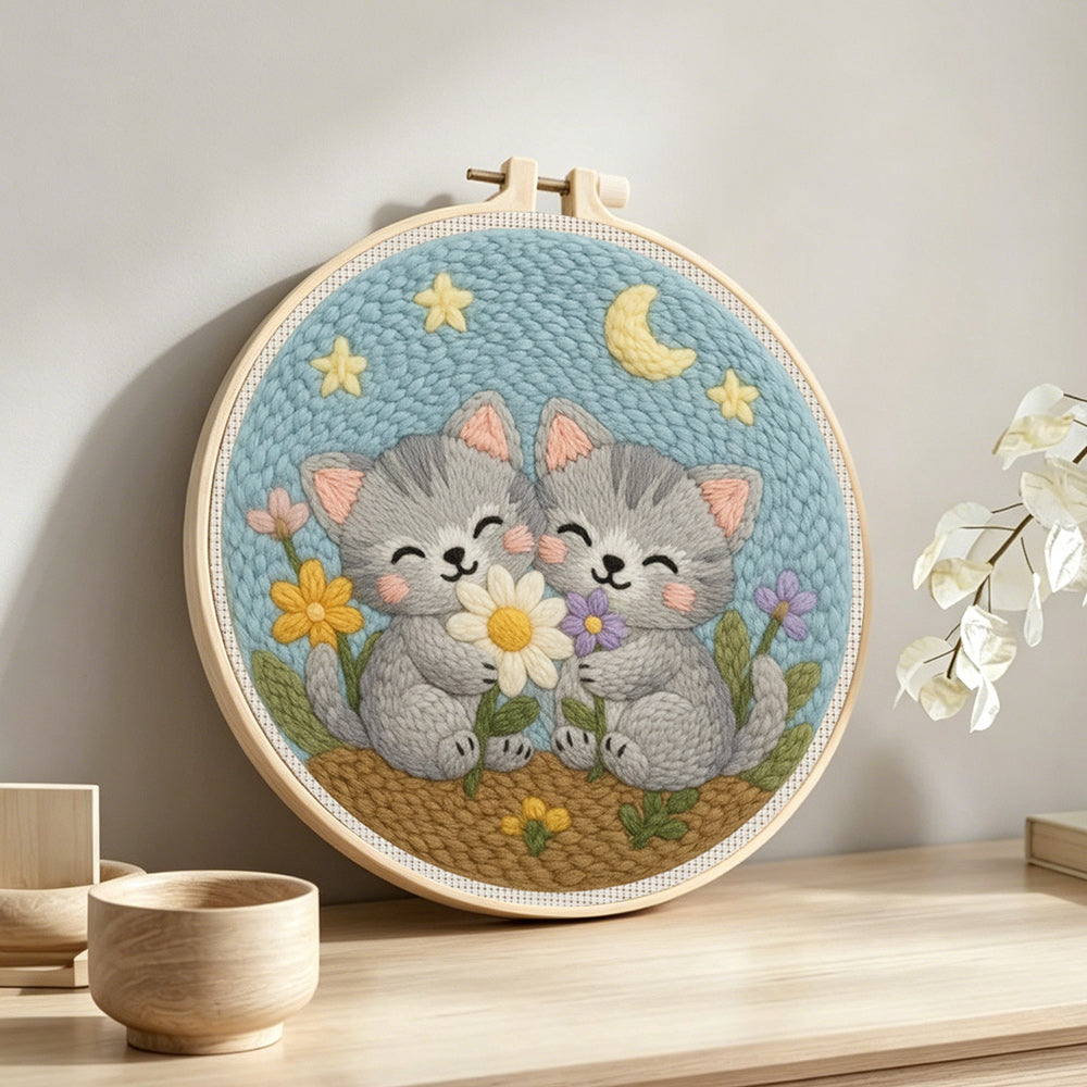 Cute gray kittens and wildflowers punch needle artwork displayed on a table