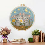 Finished cute gray kittens and wildflowers artwork displayed on a wall