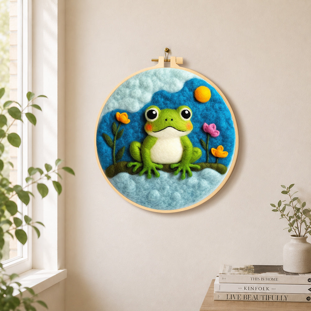 Cute green frog under the cloud needle felt wall art displayed in a bright home interior