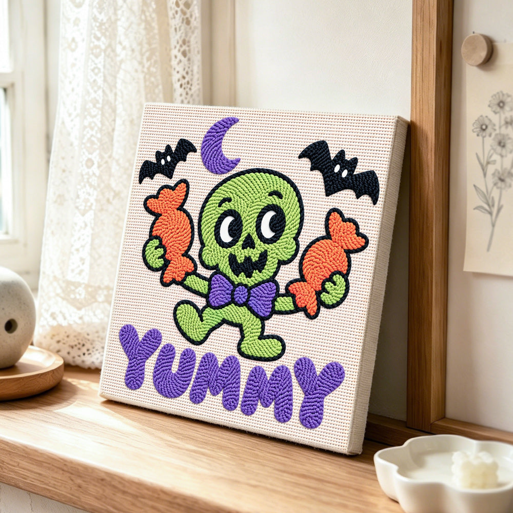 Cute green skeleton with candy punch needle artwork displayed on a table