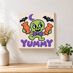 Finished cute green skeleton with candy artwork displayed on a wall