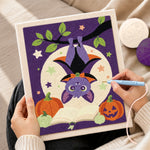 Creating handmade cute hanging bat with pumpkins punch needle artwork