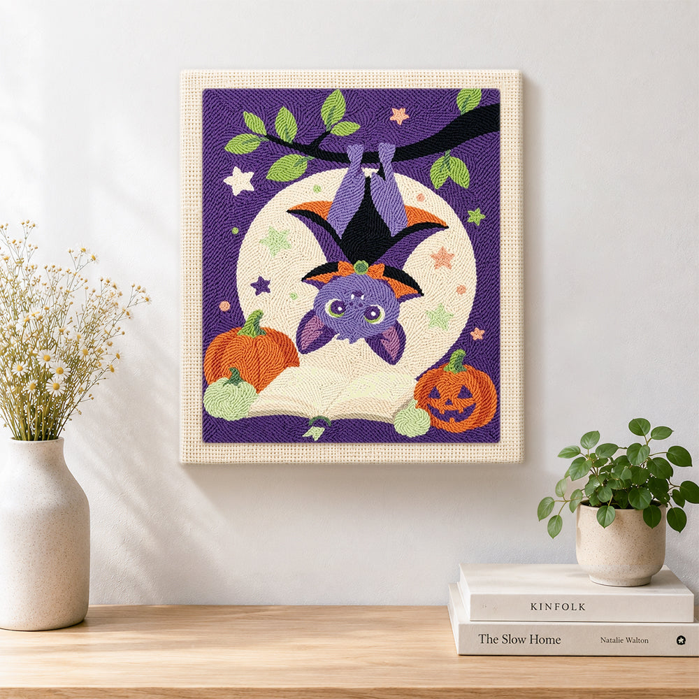 Finished cute hanging bat with pumpkins artwork displayed on a wall