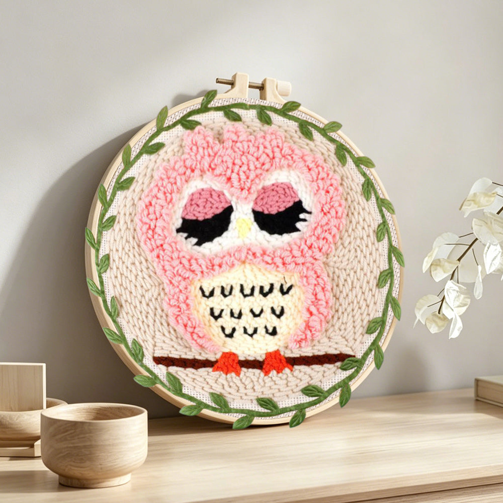 Cute pink owl punch needle artwork displayed on a table