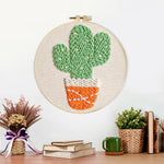 Finished cute potted twin cactus artwork displayed on a wall