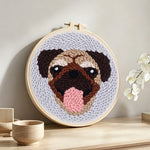 Cute pug punch needle artwork displayed on a table