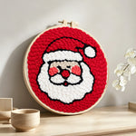 Cute santa face punch needle artwork displayed on a table