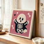Cute skeleton ghost punch needle artwork displayed on a table