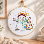 Cute snowman and tree embroidery hoop wall art displayed as warm and cozy handmade home decor