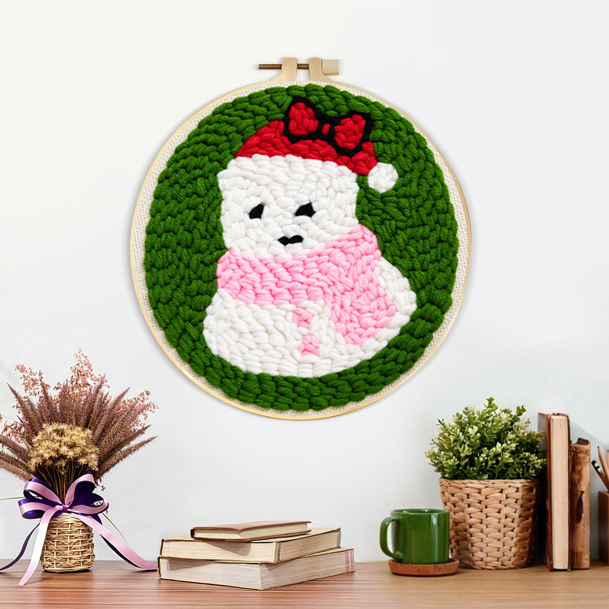 Finished cute snowman in santa hat artwork displayed on a wall