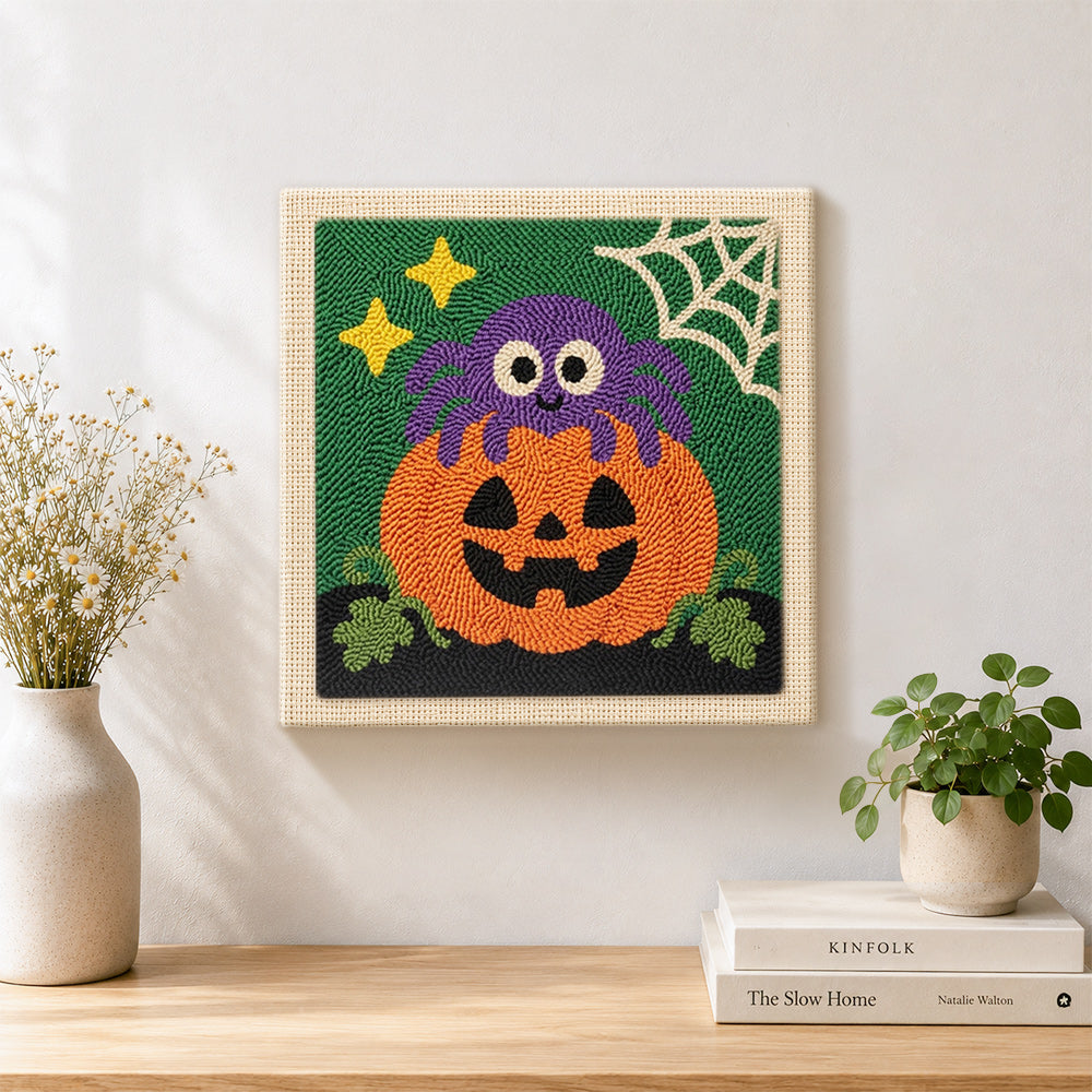 Finished cute spider pumpkin artwork displayed on a wall