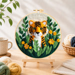 Finished cute tiger cub in the jungle needle felting displayed on a wooden easel
