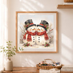 Finished cute top hat snowman couple cross stitch artwork displayed as home decor