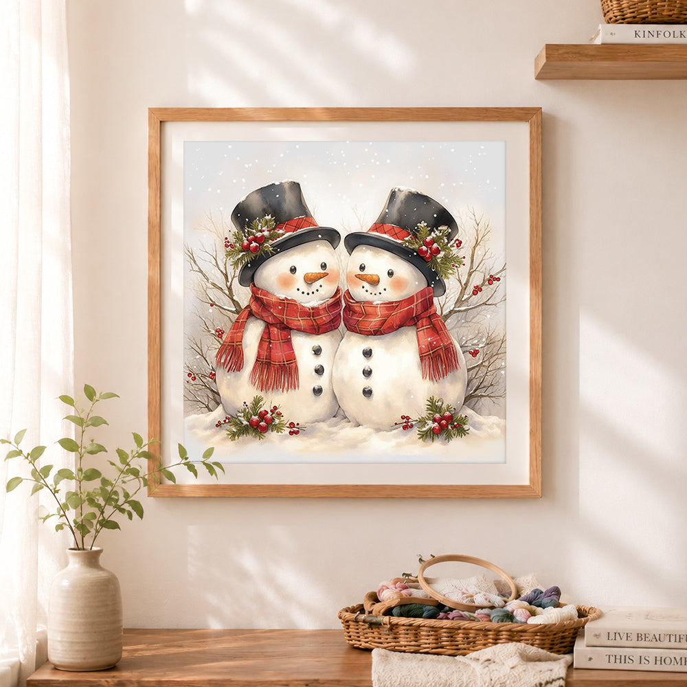 Finished cute top hat snowman couple cross stitch artwork displayed as home decor
