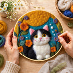 Creating the cute tuxedo cat and bright flowers wool painting by hand with a felting needle